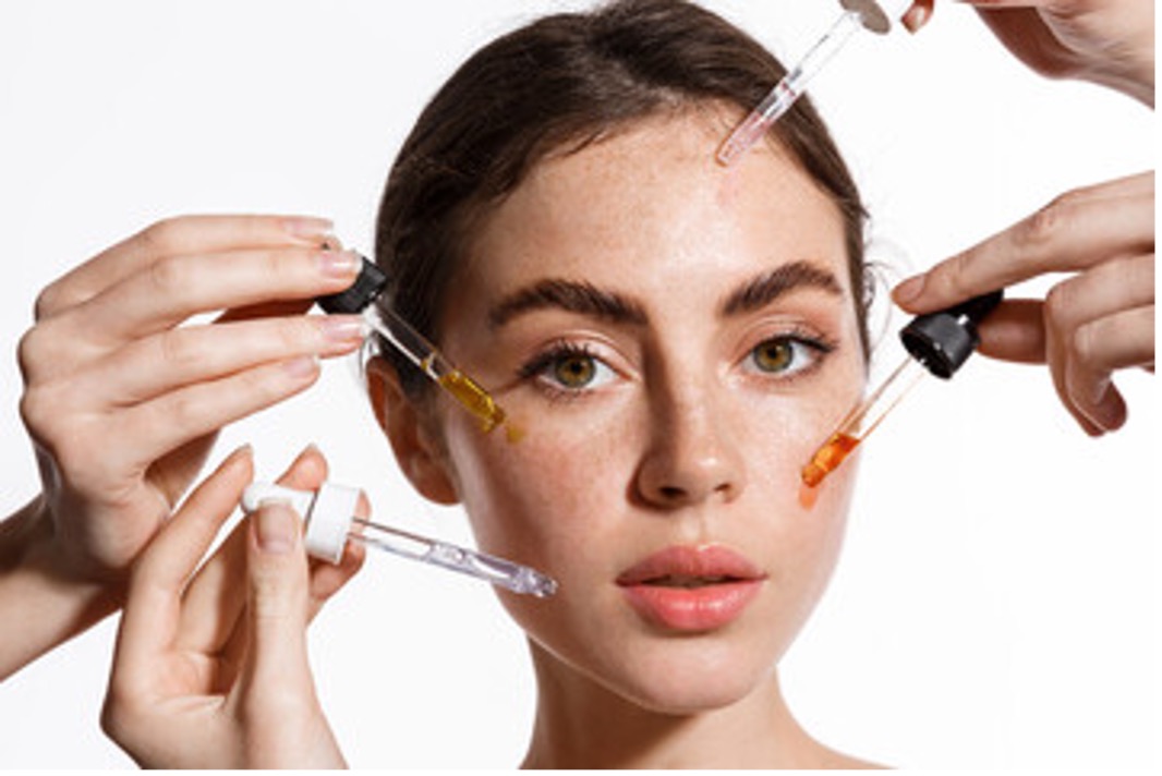 Close up photo of woman applying skincare products and oils to the face. Dermatologist's Take on Popular Trends Series, active ingredients. 